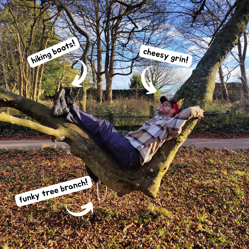A smiley Luke lounging on a warped tree branch.