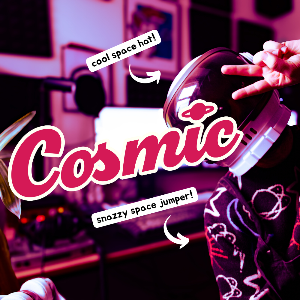 Luke sat at a desk wearing a space helmet and a space patterned jumper. He is throwing a peace sign to the camera. 2 popouts are on the image. One popout points to Luke's space helmet and reads 'cool space hat!'. the other popout points to Luke's jumper and says 'snazzy space jumper!'